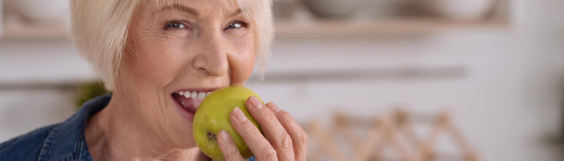 Woman biting in apple
