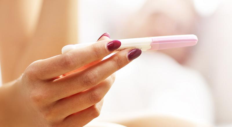 woman hands holding a pregnancy test